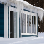 House with icicles and snow-covered ground.