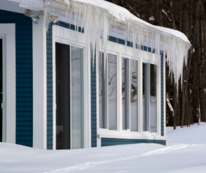House with icicles and snow-covered ground.
