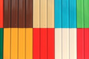 Colorful corrugated metal panels in geometric pattern.