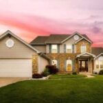 Suburban house with sunset sky background.