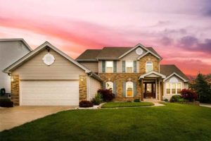 Suburban house with sunset sky background.