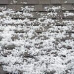 Hailstones scattered on a roof surface.