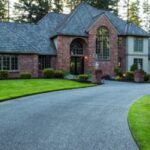 Large brick house with curved driveway.