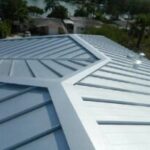Metal roof with geometric pattern and trees.