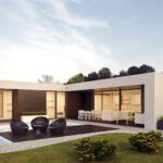 A modern house with patio furniture and outdoor dining.