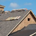Roof under construction with materials stacked.