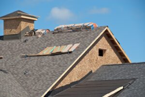Roof under construction with materials stacked.