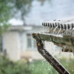 A close up of the water running out of an outdoor shower.