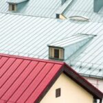 Red and green rooftops with dormer windows.
