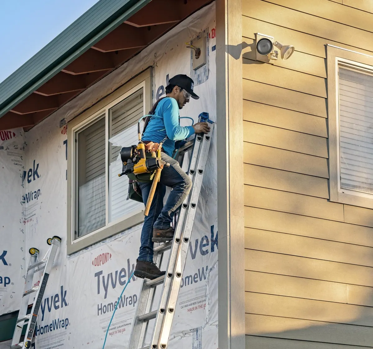 Ray’s siding installation work alongside house wrap on a residential exterior.